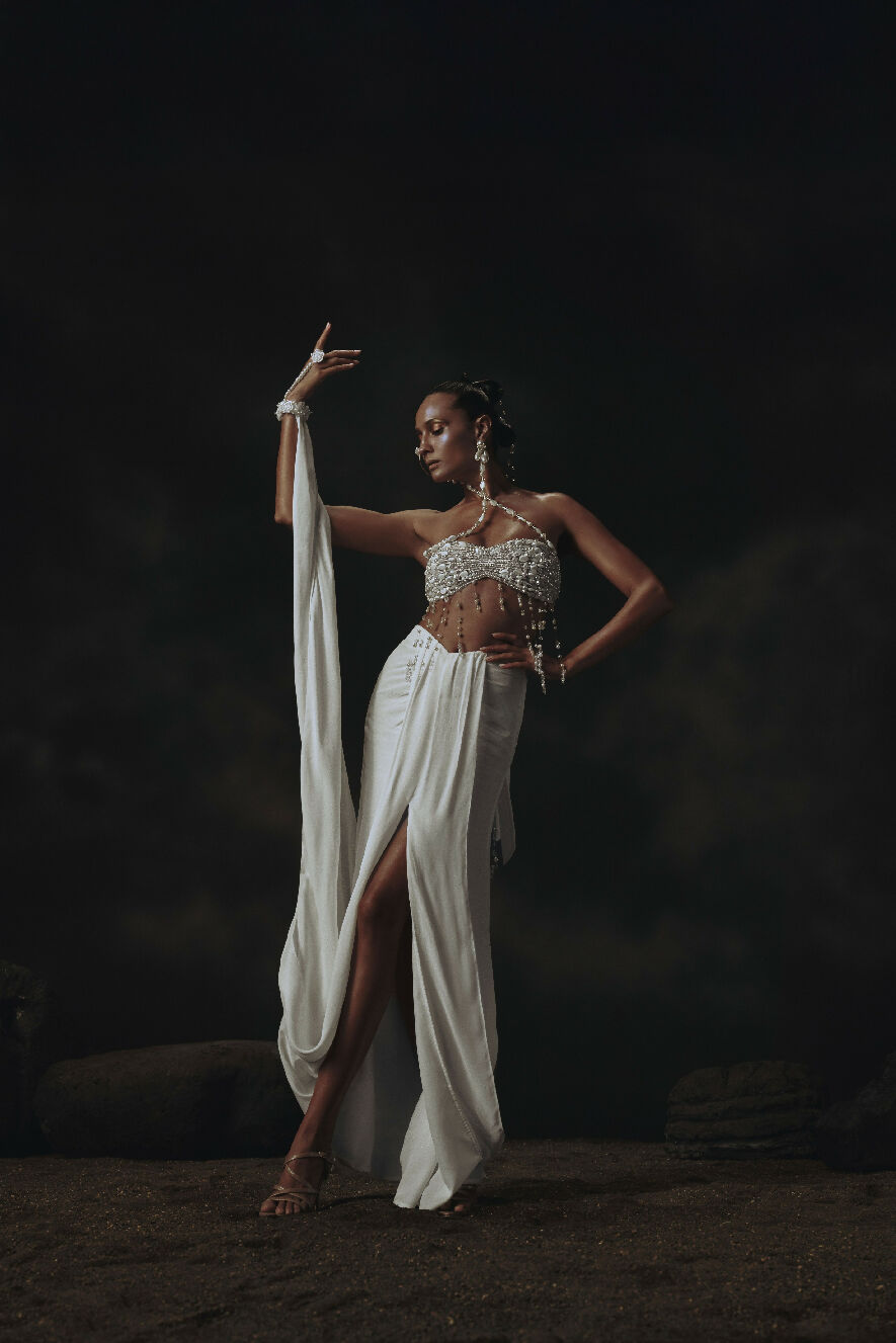 Dancer in a white outfit with a dark background