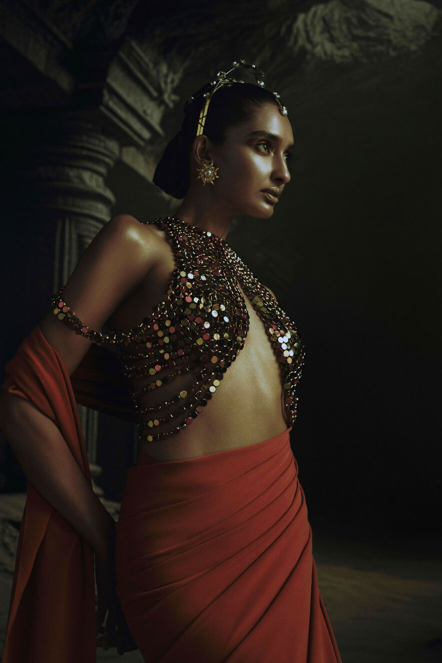 Woman in traditional attire with a dark background