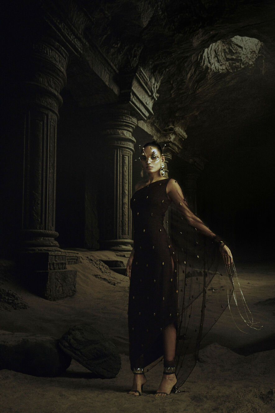 Woman in a dark, ancient ruin with a glowing mask